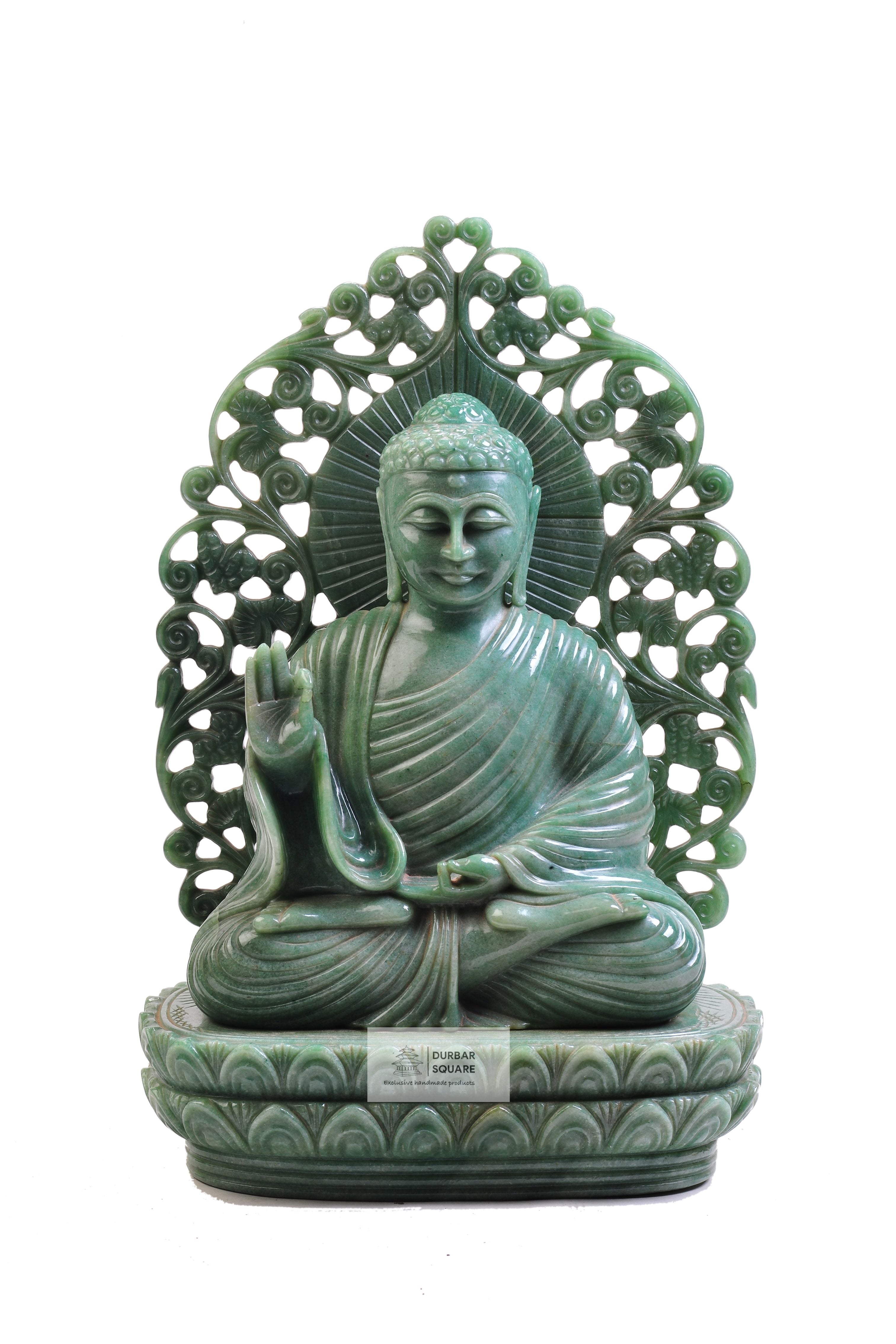 Handcarved green jade Buddha statue seated in vitarka mudra on a lotus pedestal with an openwork carved halo