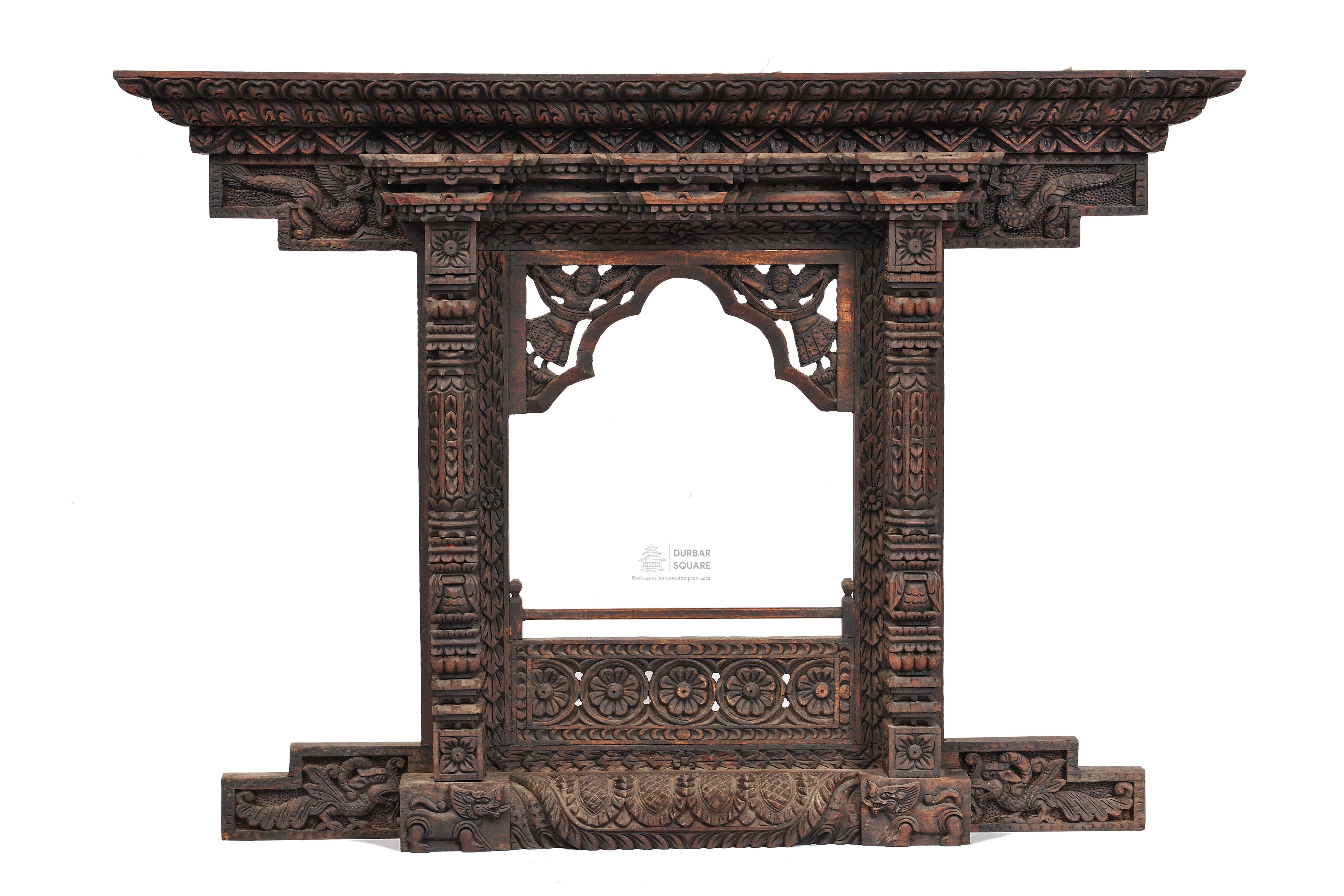 Carved wooden Kumari window frame with open centre and carved side brackets