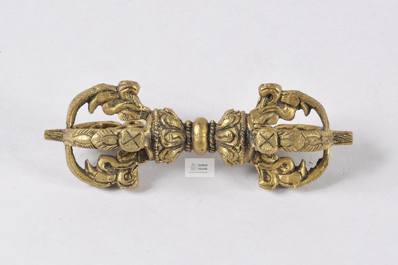 Handcrafted brass vajra with prongs curving toward the centre, gold-toned finish