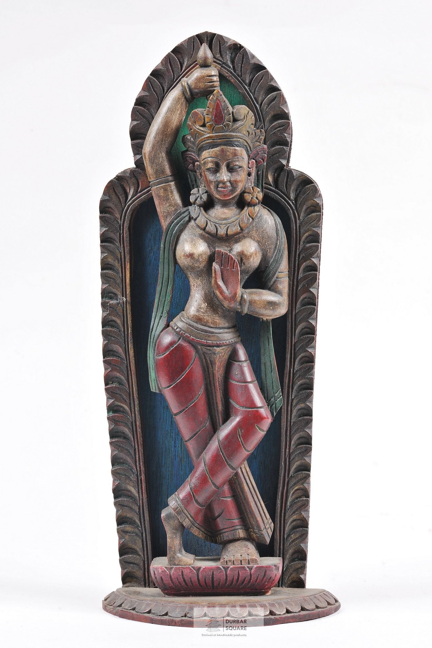 Carved wooden Mayadevi statue with antique painted finish, the standing figure raising her right arm overhead on a lotus base within a carved leaf-shaped frame