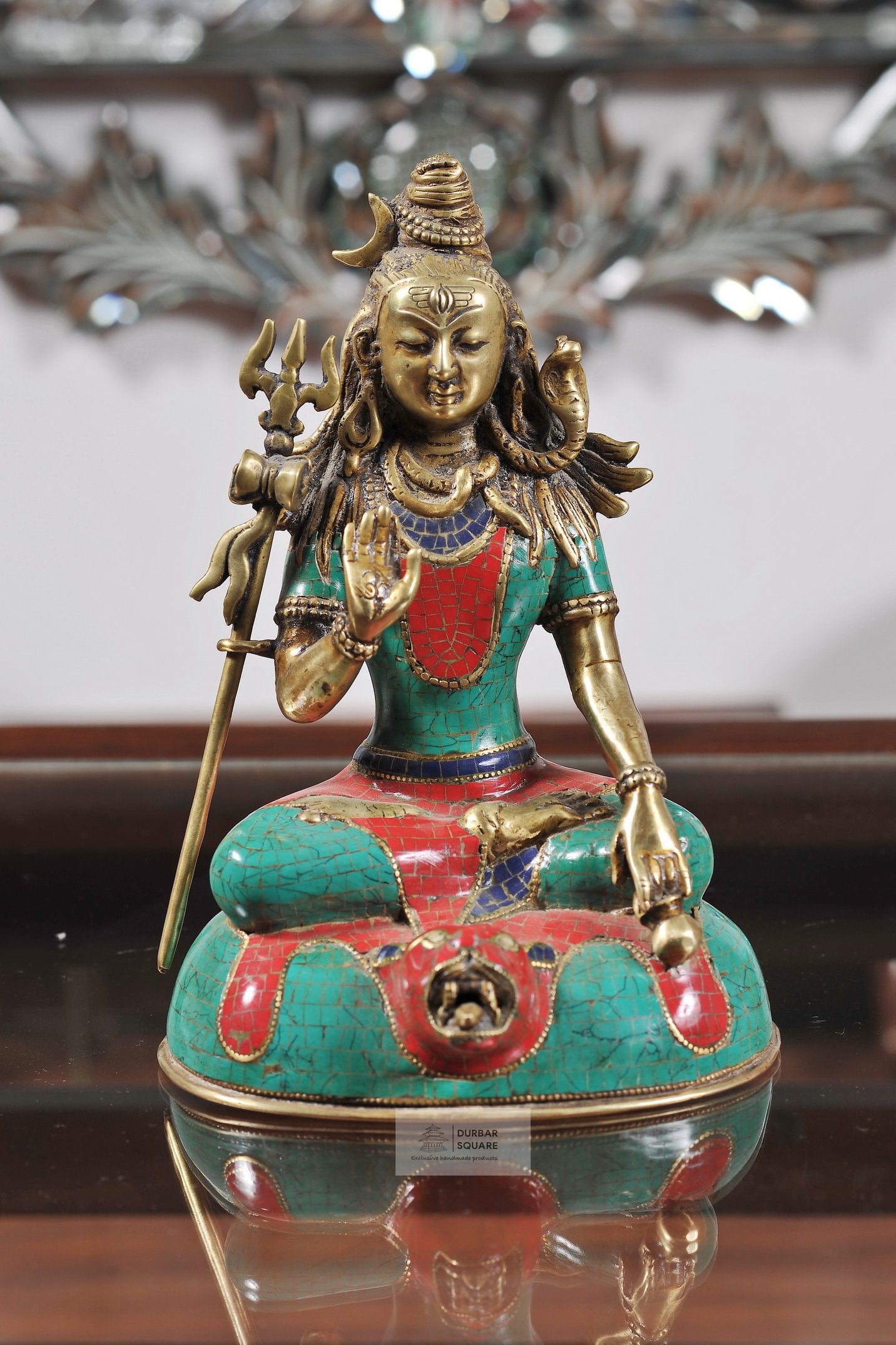 Seated handcrafted bronze Shiva statue holding a trident, with turquoise and red stone inlay
