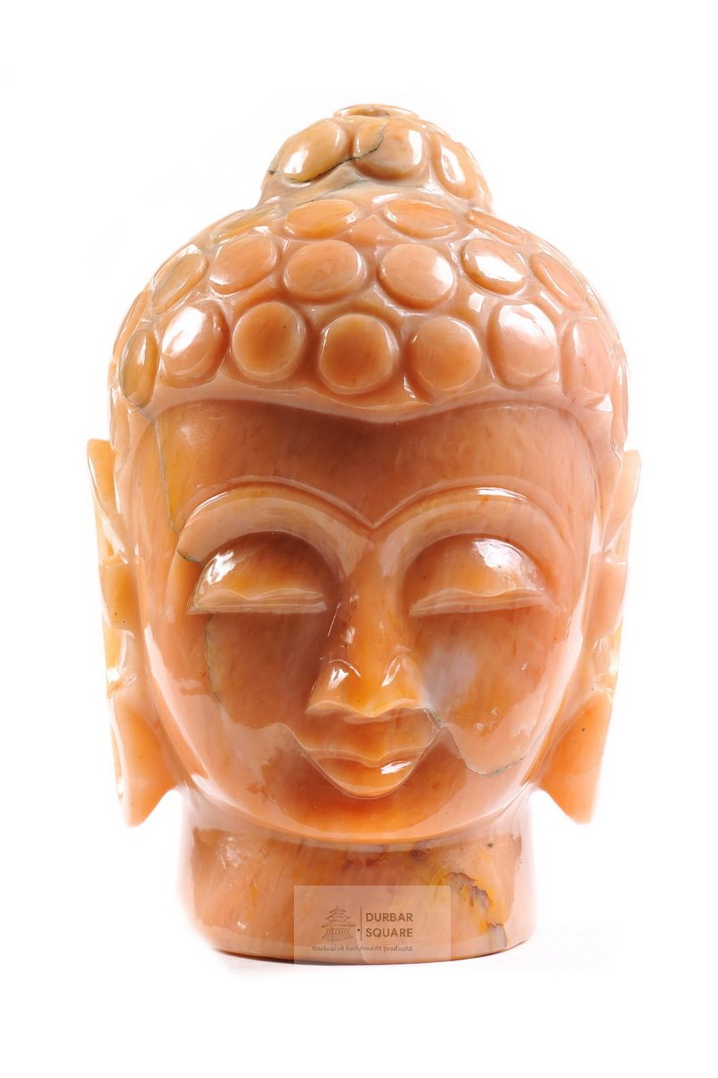 Polished orange onyx Buddha head carving with rounded curls and half-closed eyes
